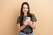 © deagreez - Photo of young brown hair business lady using smartphone during her work days enjoy modern technology isolated on beige color background