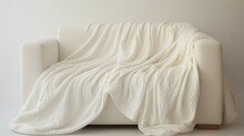 A Cozy Throw Blanket With Woven Patterns, Representing Warmth And Relaxation, Elegantly Draped On A Crisp White Canvas.