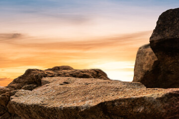 Wall Mural - rock stone on sunset sky background, rock podium outdoor with orange sunlight sky well space for dis
