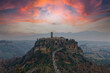 Civita di Bagnoreggio ancient medieval village in Italy. Tourists from all over the world come to see the dying city on the mountain. sunset and clouds. travel picturesque and powerful village concept