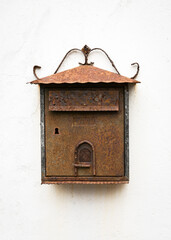 Old vintage rust metal letter box against a white stone wall in El Pinar of El Hierro Island. Canary Islands. Spain. Mailbox for paper correspondence. Copy space