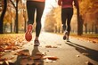 © Stavros - Couple during jogging workout in an autumn city park. Keeping fit in any age. Cropped image. Legs close-up.