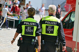 Fototapeta  - Police officers from behind at CSD parade in Munich, Bavaria