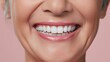 © Z A C - Senior woman radiates joy, showcasing flawless teeth in a studio with soft lighting.