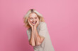 Photo of positive retired lady enjoy touch face after wrinkles peeling procedure isolated on pink color background