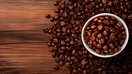 Wall Mural - Roasted coffee beans on a dark wooden table and in a cup, top view. Background of aromatic brown coffee beans scattered on the surface, copy space. Place for text