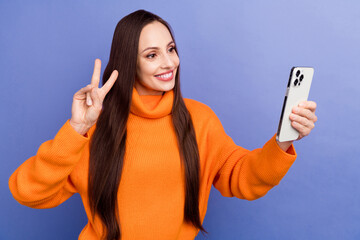 Poster - Photo young blogger show v sign recording video at camera smartphone selfie shooting during fall season isolated on violet color background