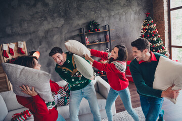 Sticker - Portrait of overjoyed positive group best friends enjoy pillow fight festive christmas time loft flat inside