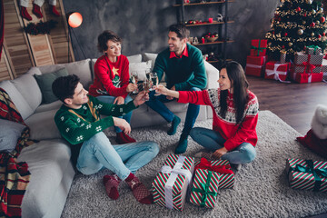 Wall Mural - Full size portrait of friendly cheerful people sit couch floor clink champagne glass new year comfort apartment indoors