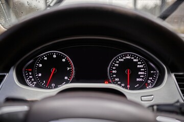 Wall Mural - Sport car speedometer and sensors on a control panel background, modern car elements close view, driving a car photo