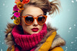 Fashionable woman with orange sunglasses and a vibrant floral headpiece against a snowy backdrop, exuding cool winter style.