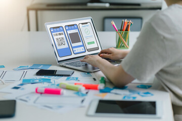 Wall Mural - creative ux ui designer working on screens for mobile responsive website development, focusing on ui