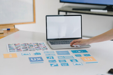 Wall Mural - creative ux ui designer working on screens for mobile responsive website development, focusing on ui