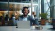 © Sajib - a young businessman, donned in a headset, engages in a video call on a laptop. Picture him seated at a table, actively participating in a business meeting, training, and even greeting with a warm smil