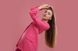 © New Africa - Beautiful young woman in pink clothes on color background