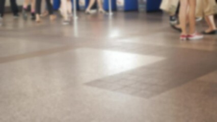 Wall Mural - defocused blurred low angle view to feet with crowd of people moving travel on the transition to the