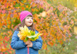 © Ermolaev Alexandr - Happy young girl with Downs syndrom holds bouquet of autumn leaves. Empty space for text