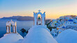 © Fokke Baarssen - White churches an blue domes by the ocean of Oia Santorini Greece during sunset