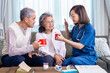 © Akarawut - Senior couple get medical advice visit from caregiver nutritionist at home while having suggestion on herbal hot chamomile tea drink for longevity, healthy sleep and cure to insomnia