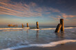 © isarescheewin - Scenery view of the concrete columns of the old port with Beautiful sky in the evening on Sao Iang Beach at Phetchaburi province. Long exposure picture