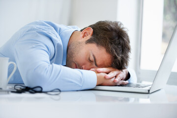 Wall Mural - Businessman, laptop and sleeping on office desk in burnout, stress or fatigue from pressure or overworked. Tired man or employee asleep on table with computer in mental health or anxiety at workplace