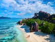© Fokke Baarssen - Anse Source d'Argent, La Digue Seychelles, a young couple of men and women on a tropical beach during a luxury vacation in Seychelles