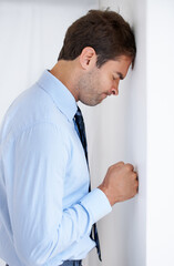 Wall Mural - Frustrated businessman, stress and mistake in debt, anxiety or burnout with fist on wall at office. Upset man or employee in financial crisis, anger management or mental health problems at workplace