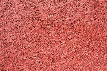 Wall Mural - Home facade texture. Red rough surface. Grunge grain. Crushed rocks in the wall. Exterior home decoration. Stucco wall pattern. Red color retro design. Noisy design background.