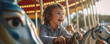 © Daniela - Happy smiling kid is enjoying ride a horse on carousel.