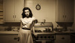 Vintage portrait of a unhappy housewife in the kitchen. Young beauty woman cooks in the kitchen retro style old design