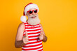 Photo of funky positive elderly guy wear new year swimsuit hat sunglass showing you empty space isolated yellow color background
