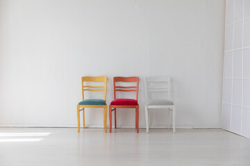 Wall Mural - Three colorful vintage chairs in white room interior