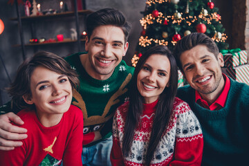 Wall Mural - Photo of four positive funky buddies toothy smile cuddle enjoy fairy christmas spirit apartment inside