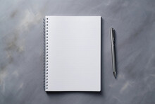 Notepad And A Pen On An Untitled Grey Surface.mock Up