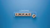 Wooden blocks spelling 'IMPACT' with a loading progress bar on a blue background, making difference concept