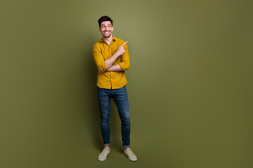 Canvas Print - Full length photo of satisfied man promoter presenting empty space clothes brand collection empty space isolated on khaki color background