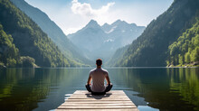 Rear View Of A Man Doing Yoga Against The Backdrop Of A Lake In The Majestic Mountains