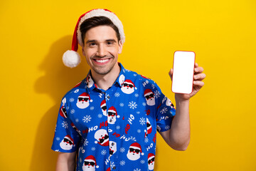 Poster - Photo of guy hold christmas product new iphone announcement empty space device touchscreen website app isolated on yellow color background