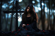 woman in black dress with red roses sitting in front of iron cross in forest