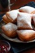 New Orleans Style Beignets, Fried Dough Fritters Topped with Powdered Sugar and Raspberry Sauce	