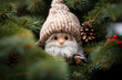 © July P - Fairy tale elf in a knitted hood in the branches of a Christmas tree. Christmas handmade toy.