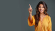 Happy indian woman pointing her finger at copy space for promotion