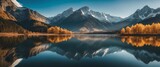 Fototapeta Fototapety góry  - Shoot a panoramic view of a majestic mountain range under a clear blue sky, with a mirror-like lake