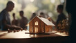Illuminated Model Home with People in Meeting Blur Background Ideal for Real Estate and Architecture Design Concepts