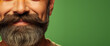 Close-up of male face with groomed stylish beard and mustache isolated on a colored background with copy space, barbershop banner template.