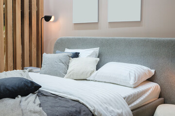 Poster - Interior of a modern bedroom in an apartment, hotel or private house with a bed and pillows