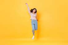 Cheerful Asian Woman In Casual Clothes Smiling And Jumping With Hand Up In Colorful Yellow Color Isolated Background Studio Shot