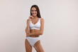 © New Africa - Young woman in stylish bikini on white background. Space for text