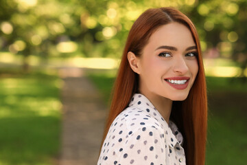 Poster - Portrait of happy young woman outdoors. Space for text. Attractive lady smiling and posing for camera