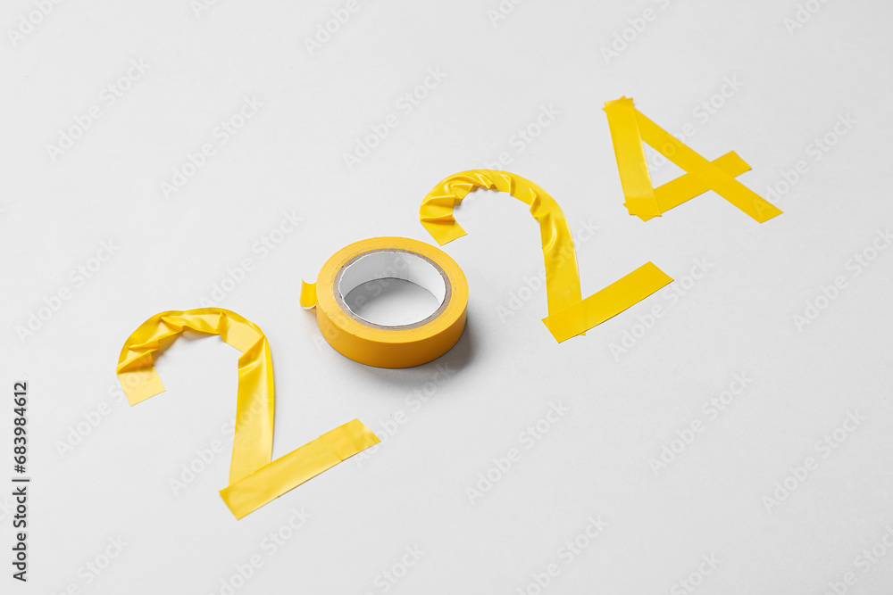 Figure 2024 made of adhesive tape on grey background